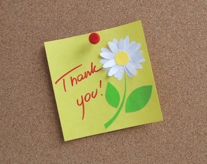 Thank you on a sticky note on a pinboard