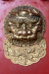 a lion and dragon door handle in the Forbidden City