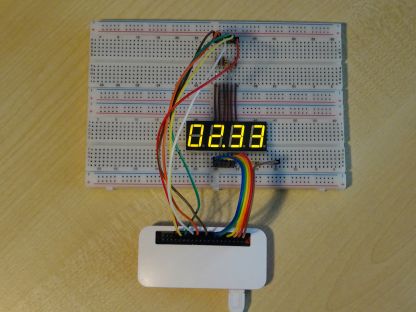 A four-digit display wired up to a Raspberry Pi on a breadboard, showing 2 hours and 33 minutes remaining